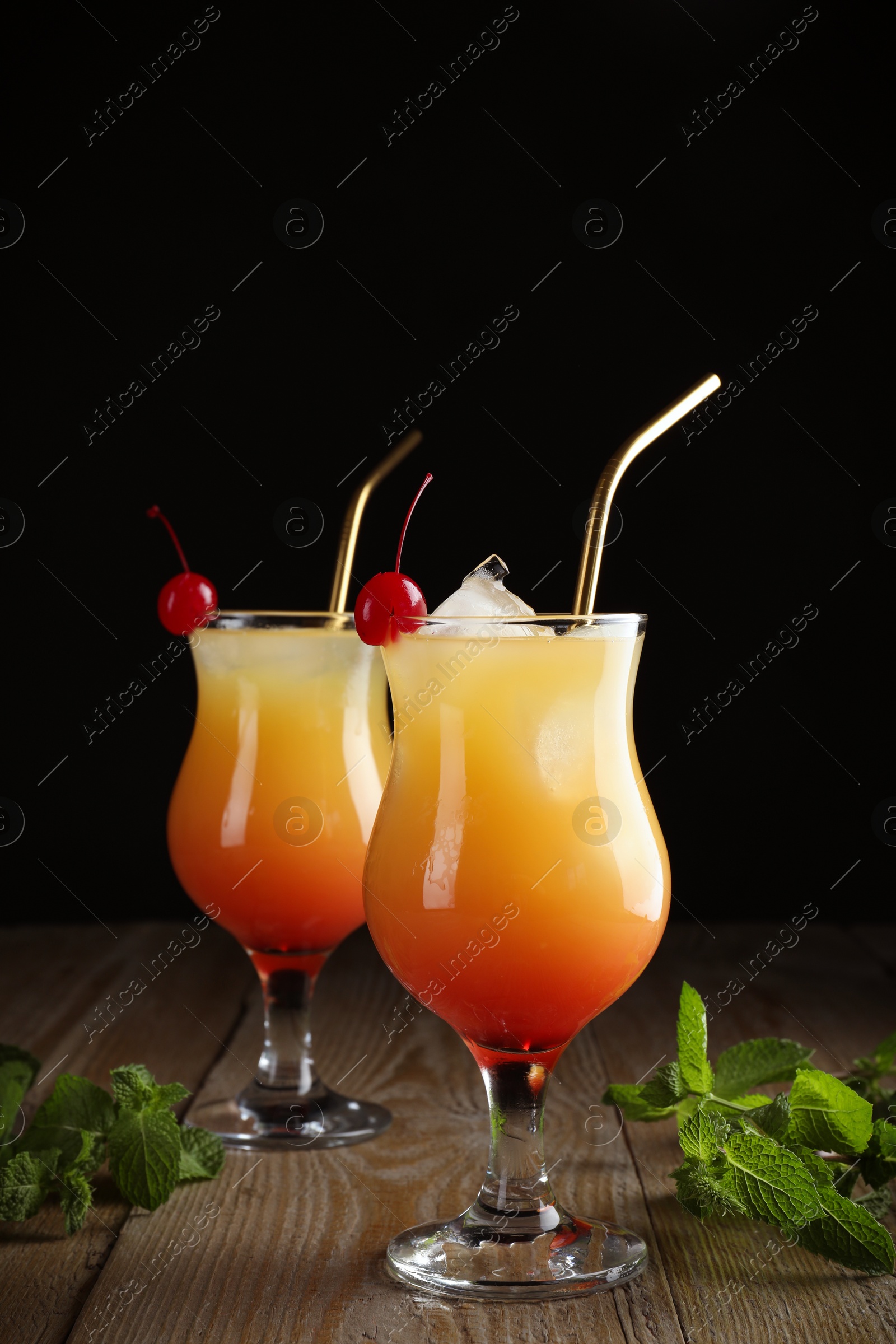 Photo of Just made appetizing cocktails Sex on the Beach, black background