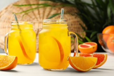 Photo of Delicious orange soda water on white wooden table