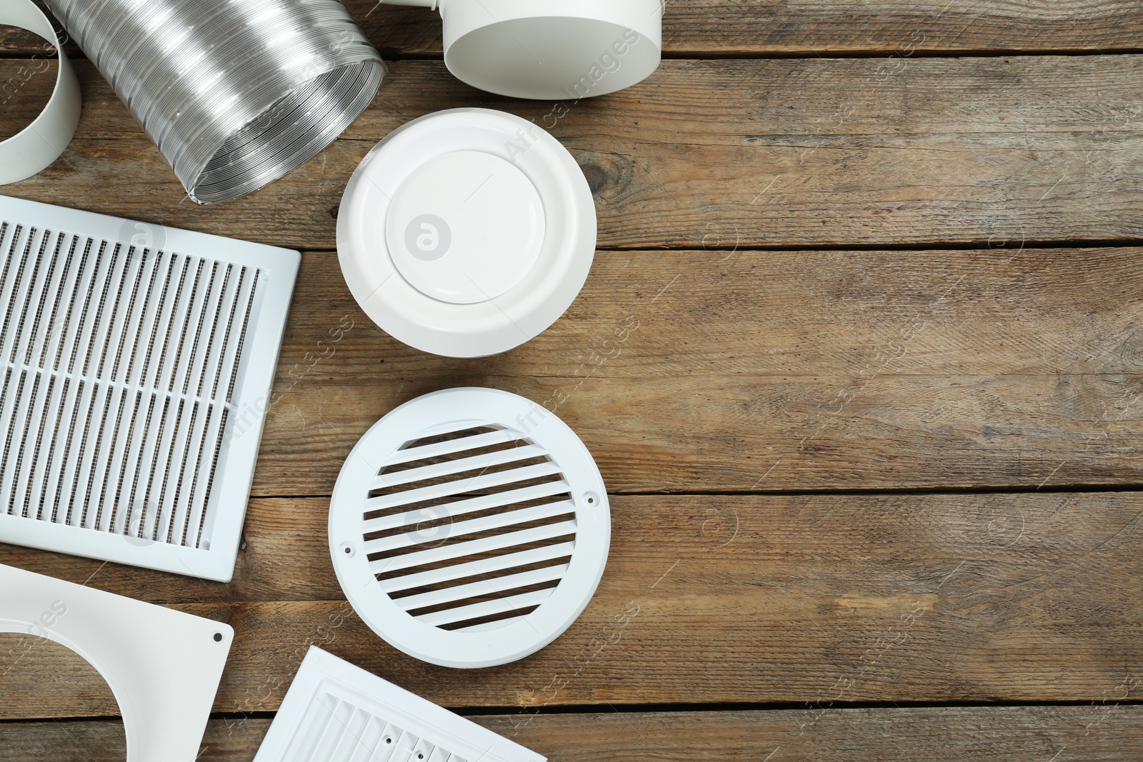 Photo of Parts of home ventilation system on wooden surface, flat lay. Space for text