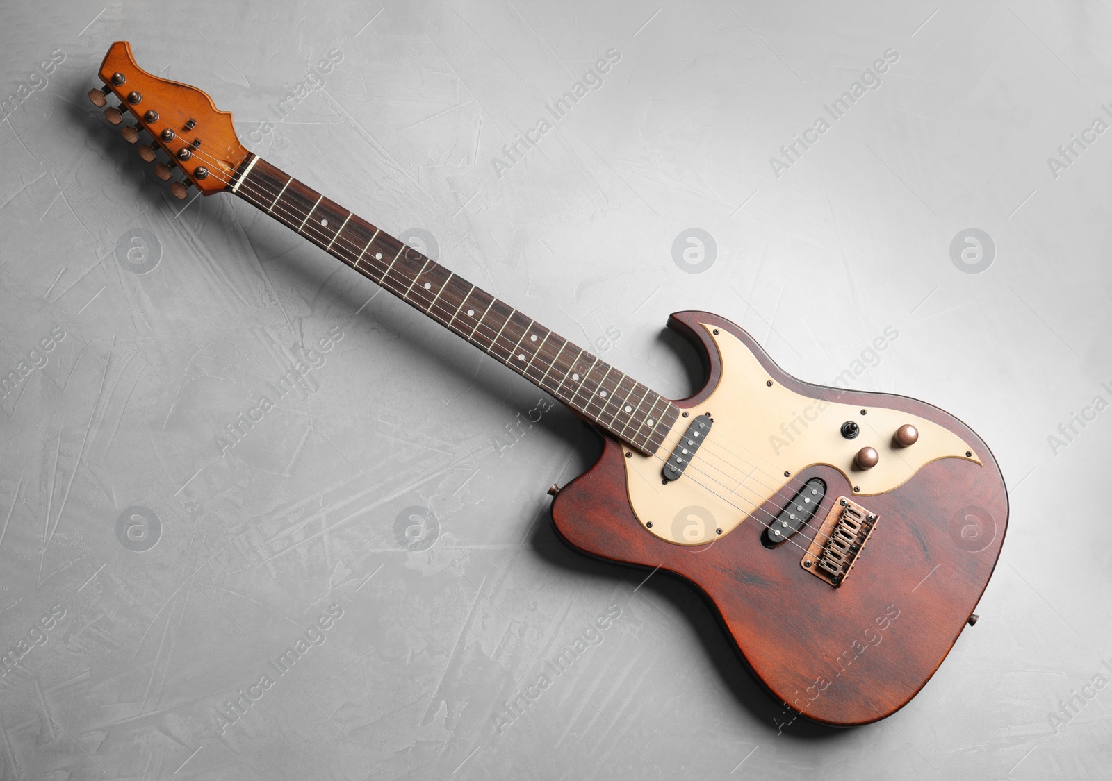 Photo of Modern electric guitar on color background, top view