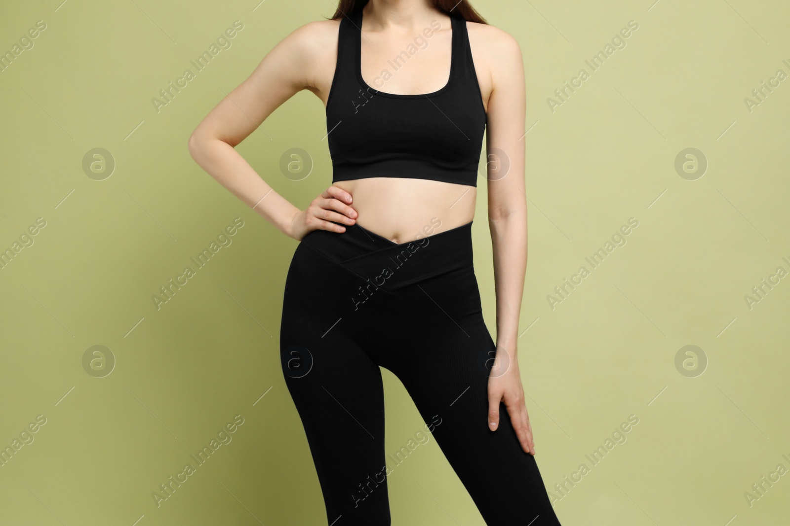 Photo of Woman with slim body on green background, closeup