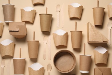 Photo of Flat lay composition with eco friendly food packagings on beige background