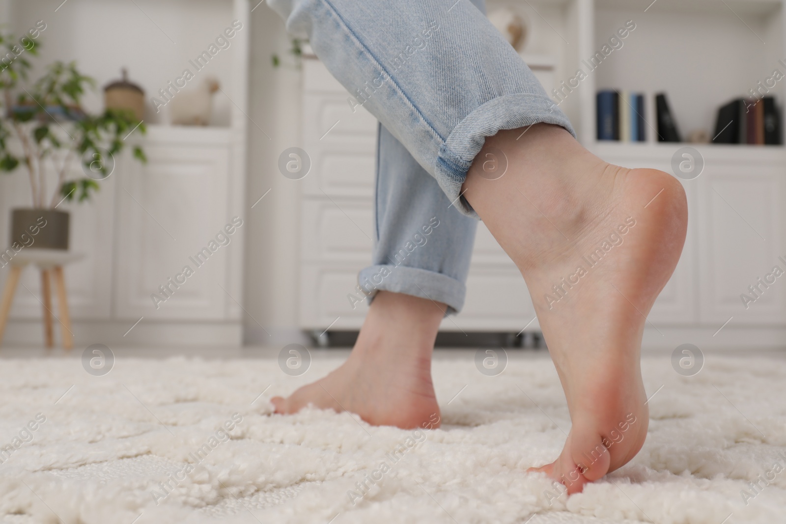 Photo of Woman standing on beige carpet in room, closeup. Space for text