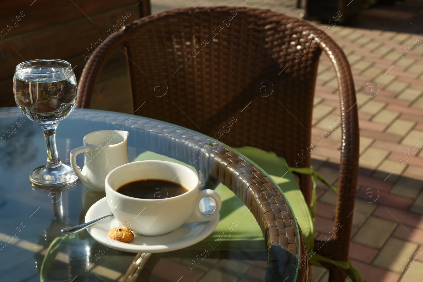 Photo of Cup of fresh aromatic coffee at table in cafe