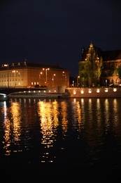 Photo of Beautiful view of illuminated city near river at night