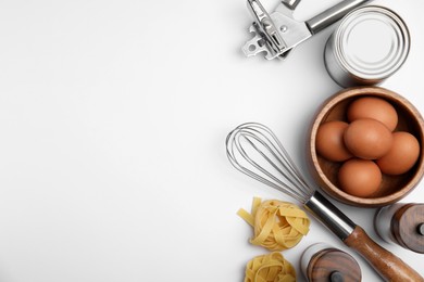 Photo of Cooking utensils and ingredients on white background, top view