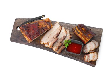 Photo of Pieces of tasty baked pork belly and sauce isolated on white, top view