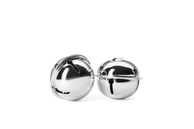 Photo of Shiny silver sleigh bells on white background