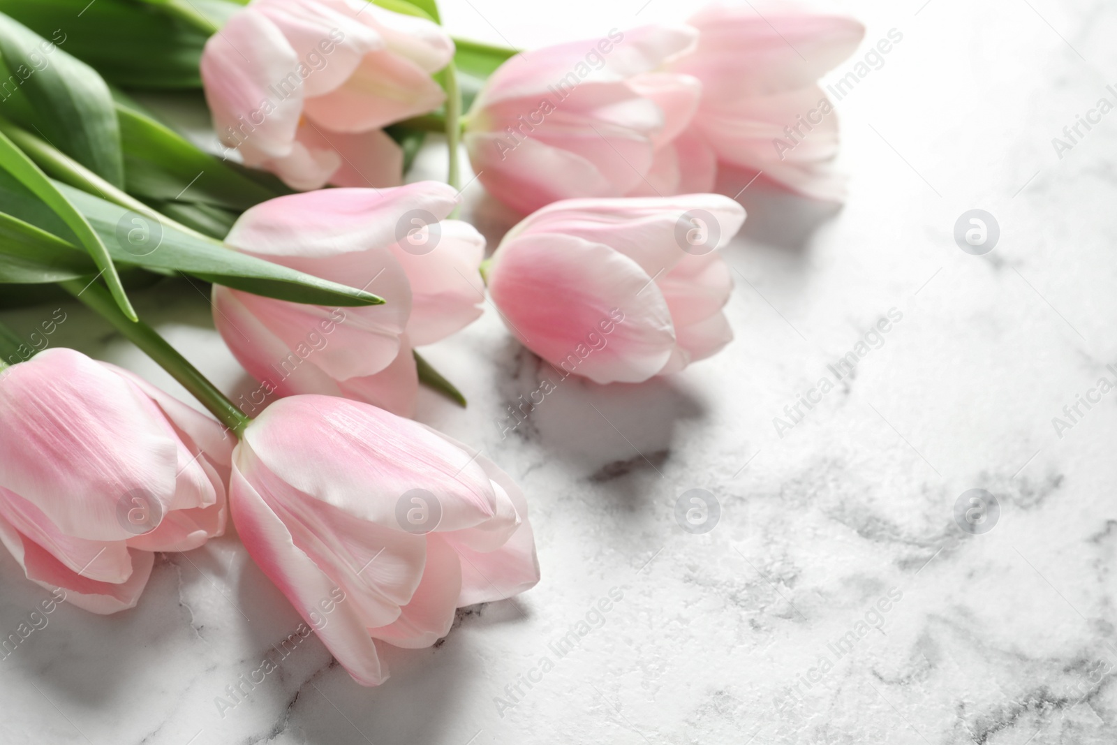 Photo of Beautiful tulips for Mother's Day on marble background