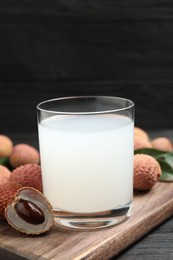 Lychee juice and fresh fruits on black wooden table