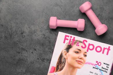 Photo of Dumbbells and magazine on brown textured table, flat lay. Space for text