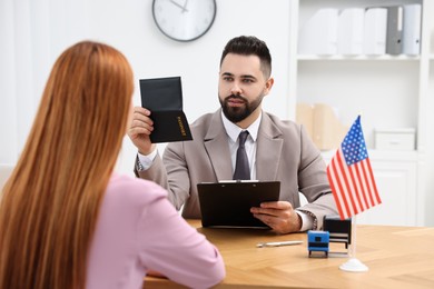 Photo of Immigration to United States. Woman having interview with embassy worker in office