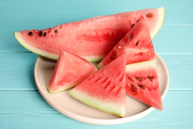 Photo of Yummy cut watermelon on light blue wooden table, closeup