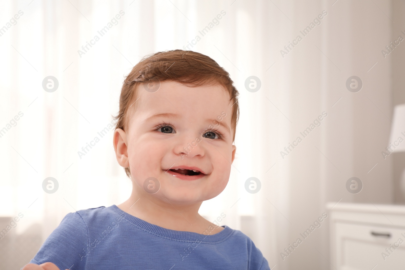 Photo of Happy baby boy in room at home