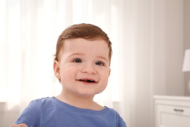 Photo of Happy baby boy in room at home