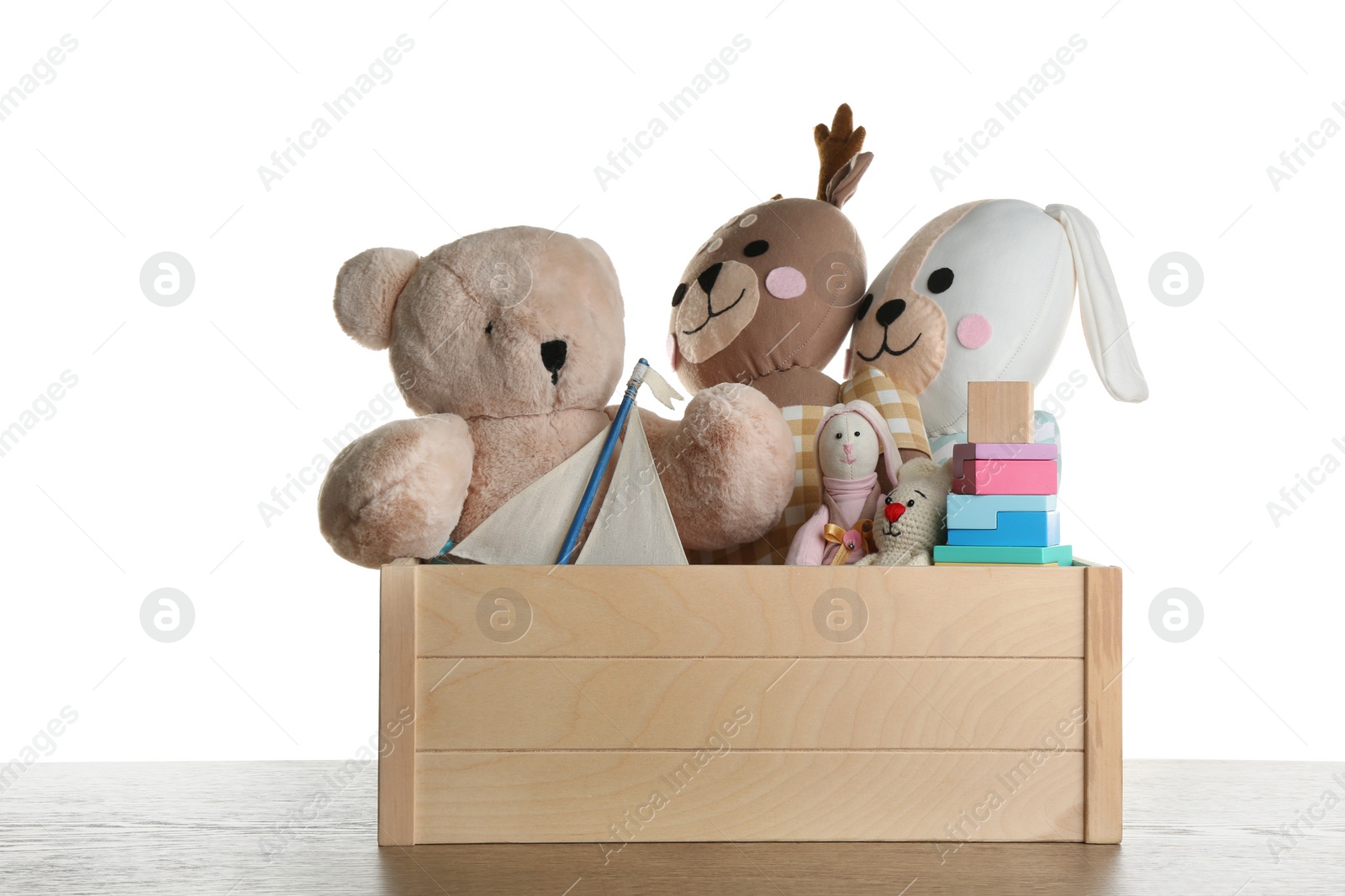 Photo of Set of different toys on wooden table against white background