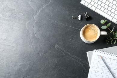 Flat lay composition with coffee on dark background, space for text