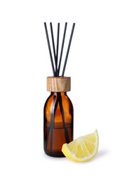 Photo of Aromatic reed air freshener and slice of lemon on white background