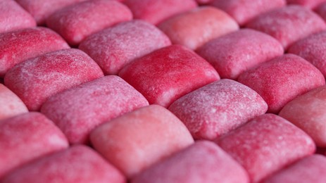 Photo of Many pink chewing gums as background, closeup