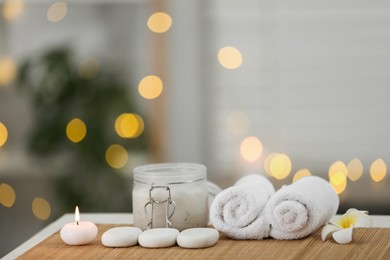 Photo of Composition with spa stones and cosmetic product on table indoors, space for text