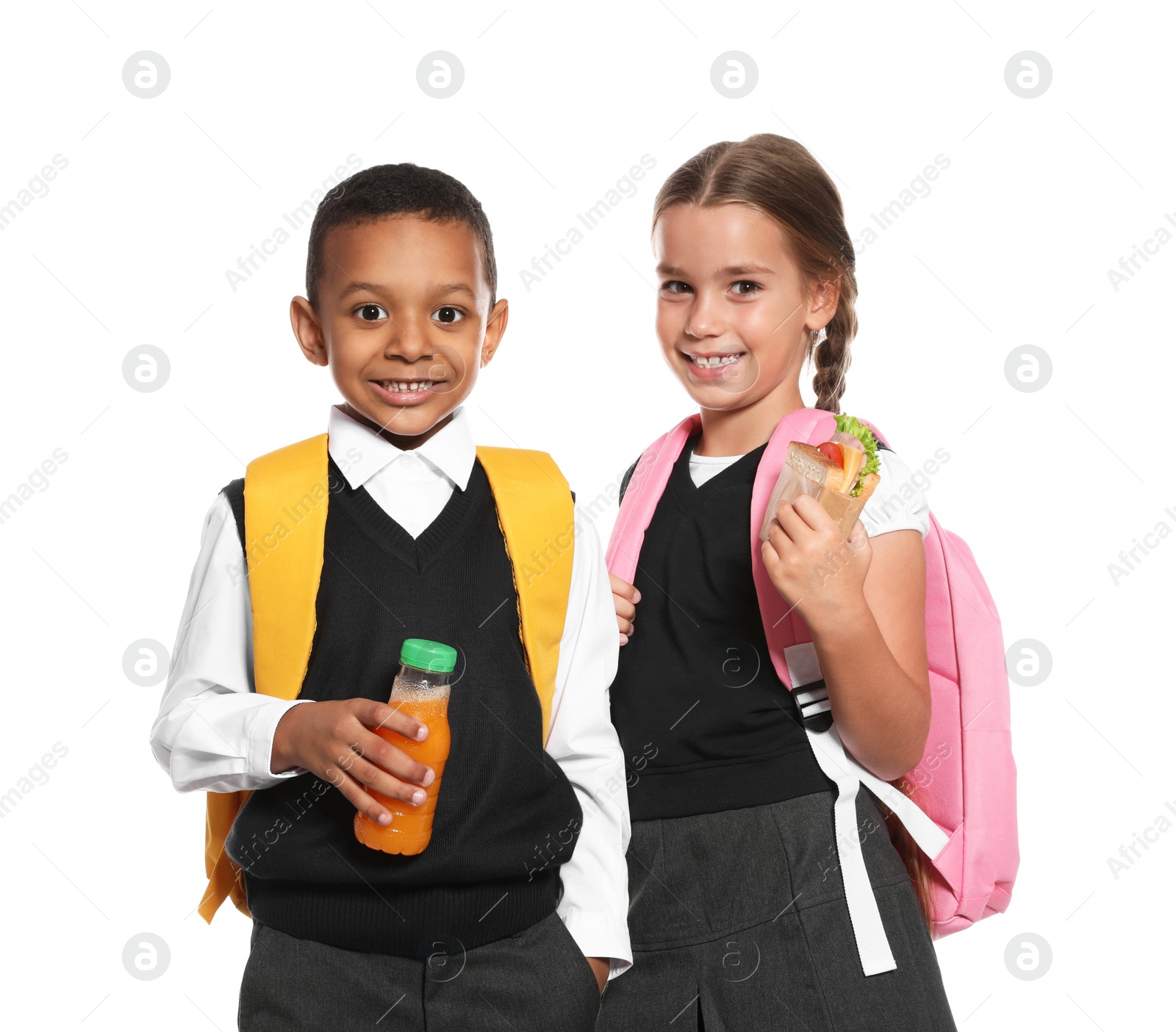 Photo of Schoolchildren with healthy food and backpacks on white background