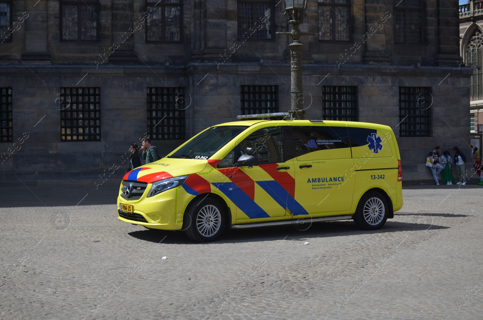 Photo of AMSTERDAM, NETHERLANDS - JULY 16, 2022: Modern ambulance vehicle on city street