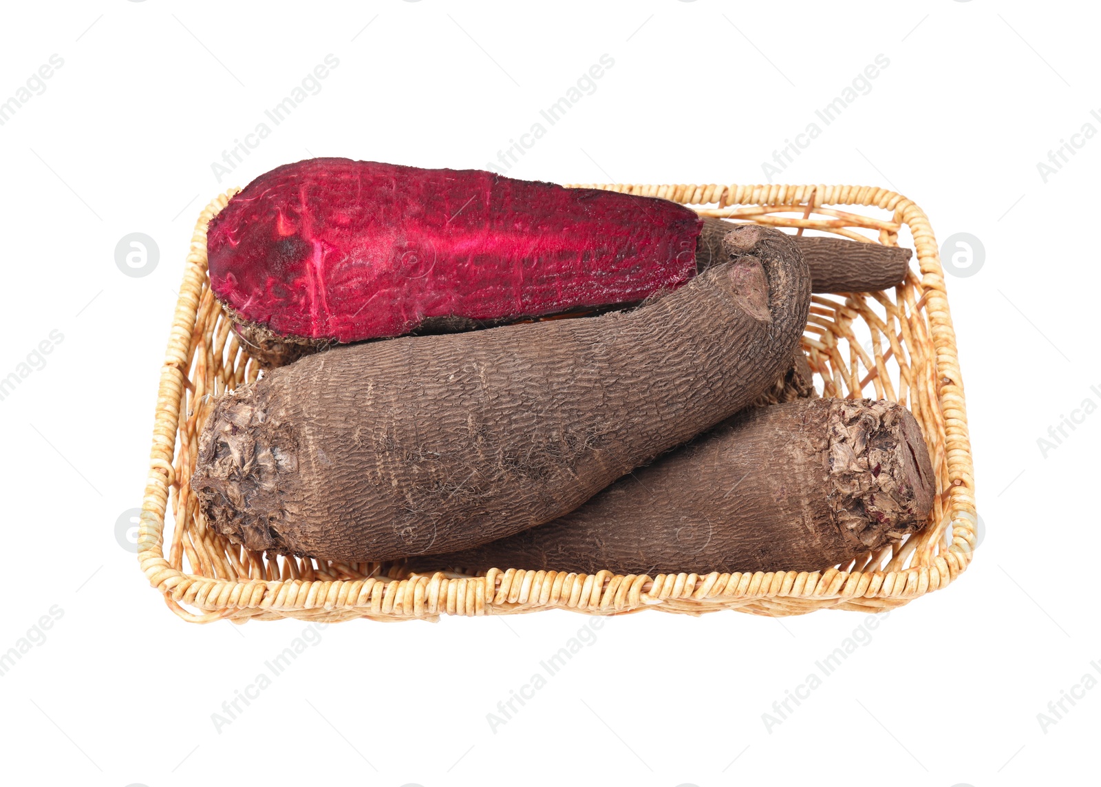 Photo of Whole and cut red beets in wicker basket isolated on white