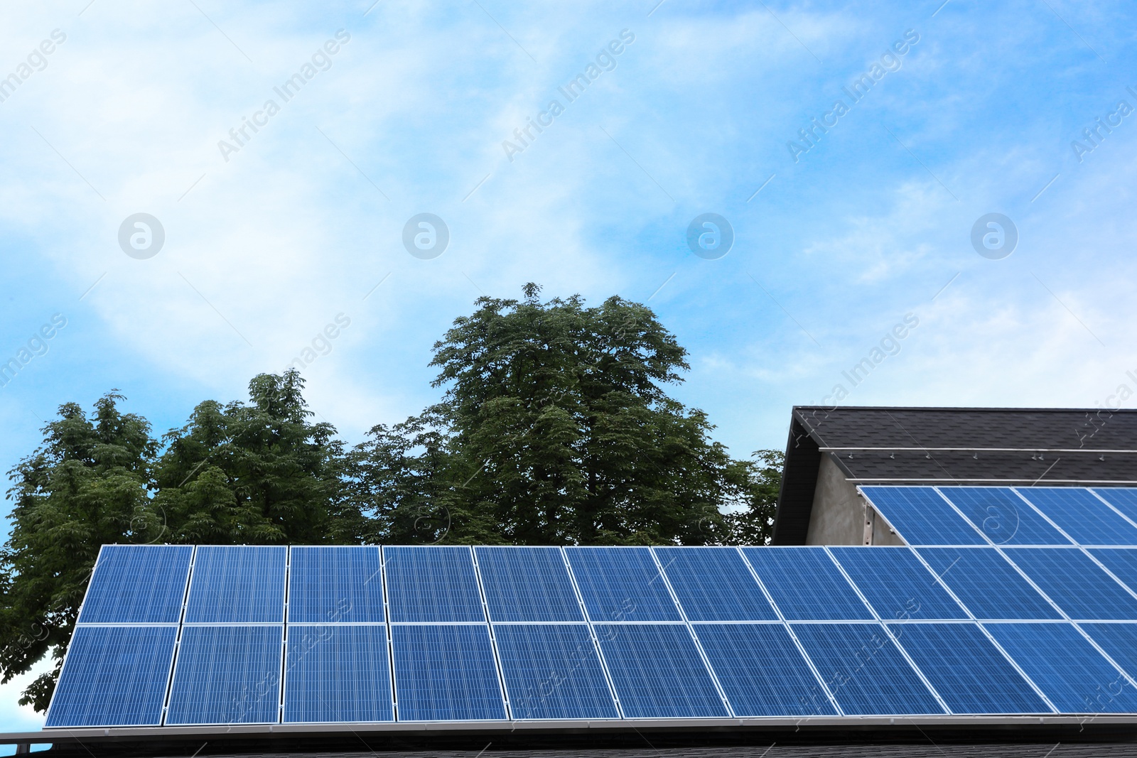 Photo of Building with installed solar panels on roof. Alternative energy source