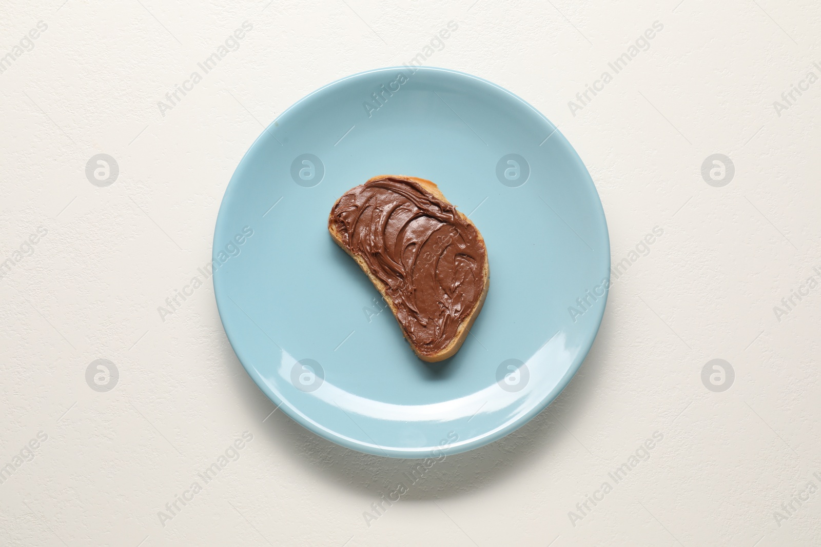 Photo of Toast with tasty nut butter on white table, top view