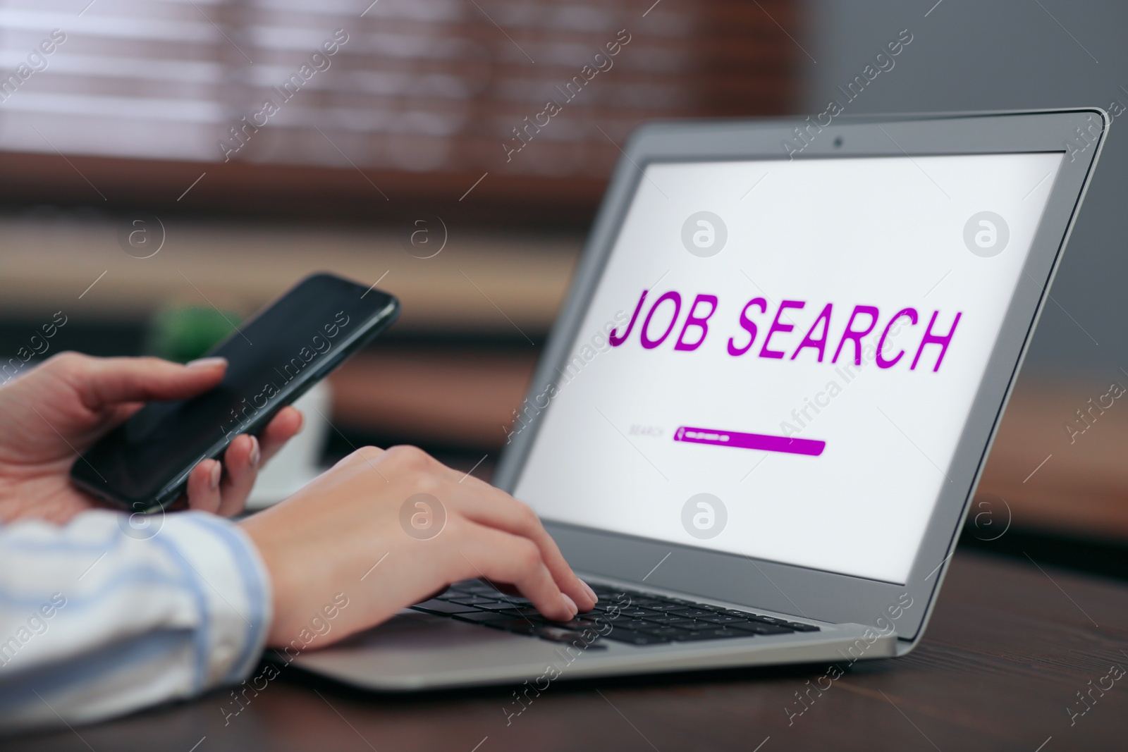 Image of Woman using modern laptop for job search at table, closeup