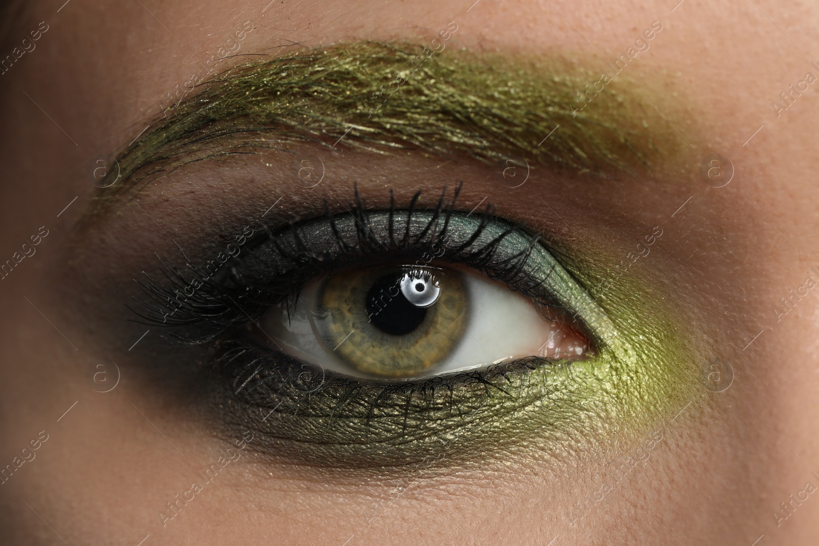 Photo of Young woman with evening makeup, closeup. Eye shadow product