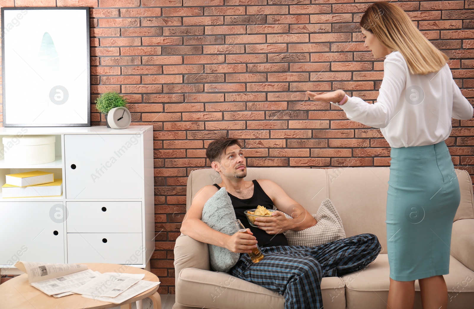 Photo of Lazy husband quarrelling with hardworking wife at home