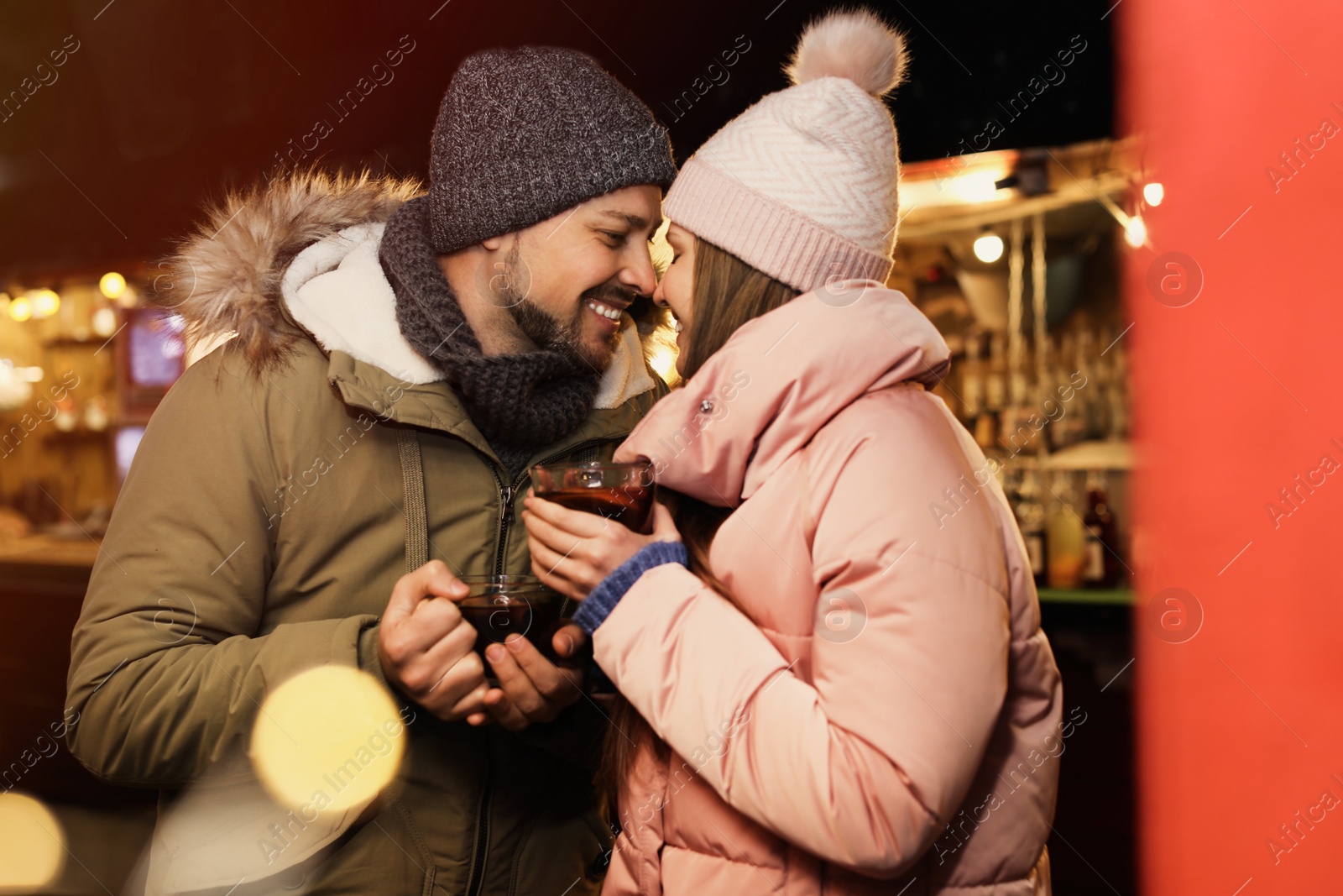 Photo of Happy couple with mulled wine at winter fair