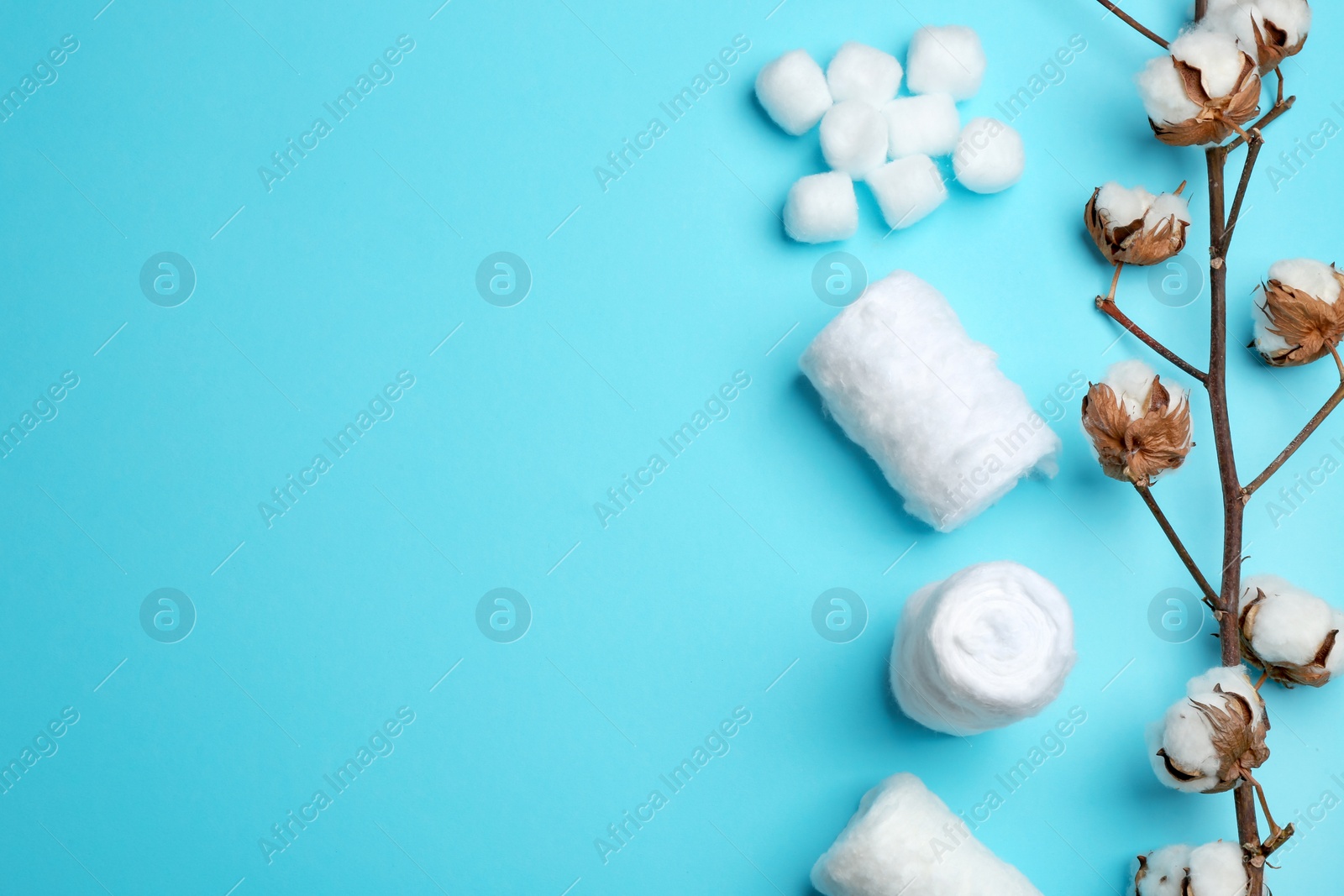 Photo of Flat lay composition with cotton rolls and balls on color background, space for text