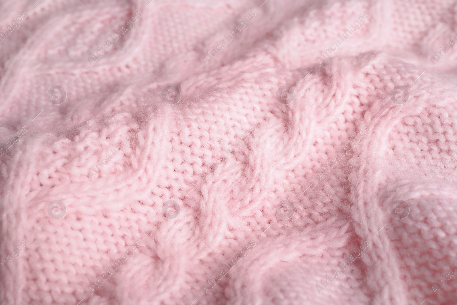 Photo of Pink knitted sweater as background, closeup view