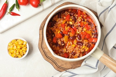 Flat lay composition with chili con carne on light background