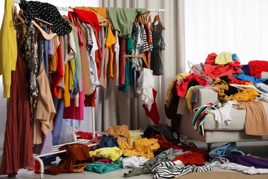 Photo of Mess of clothes all over room. Fast fashion