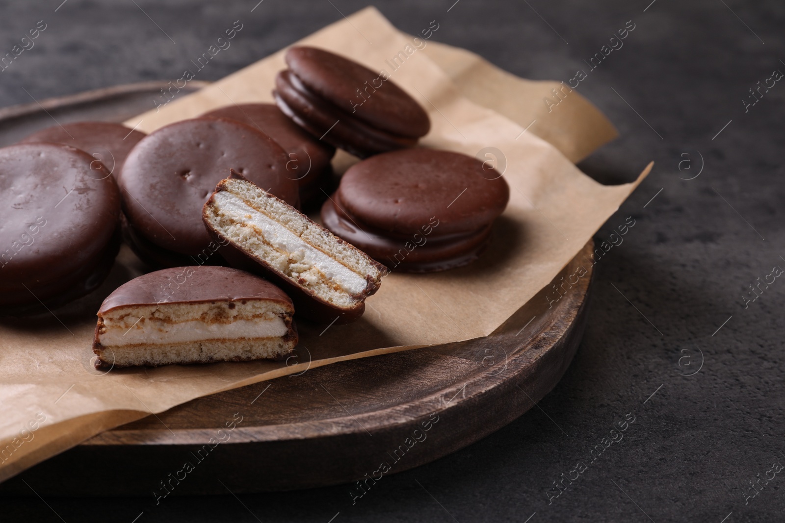 Photo of Tasty choco pies on grey table. Snack cakes