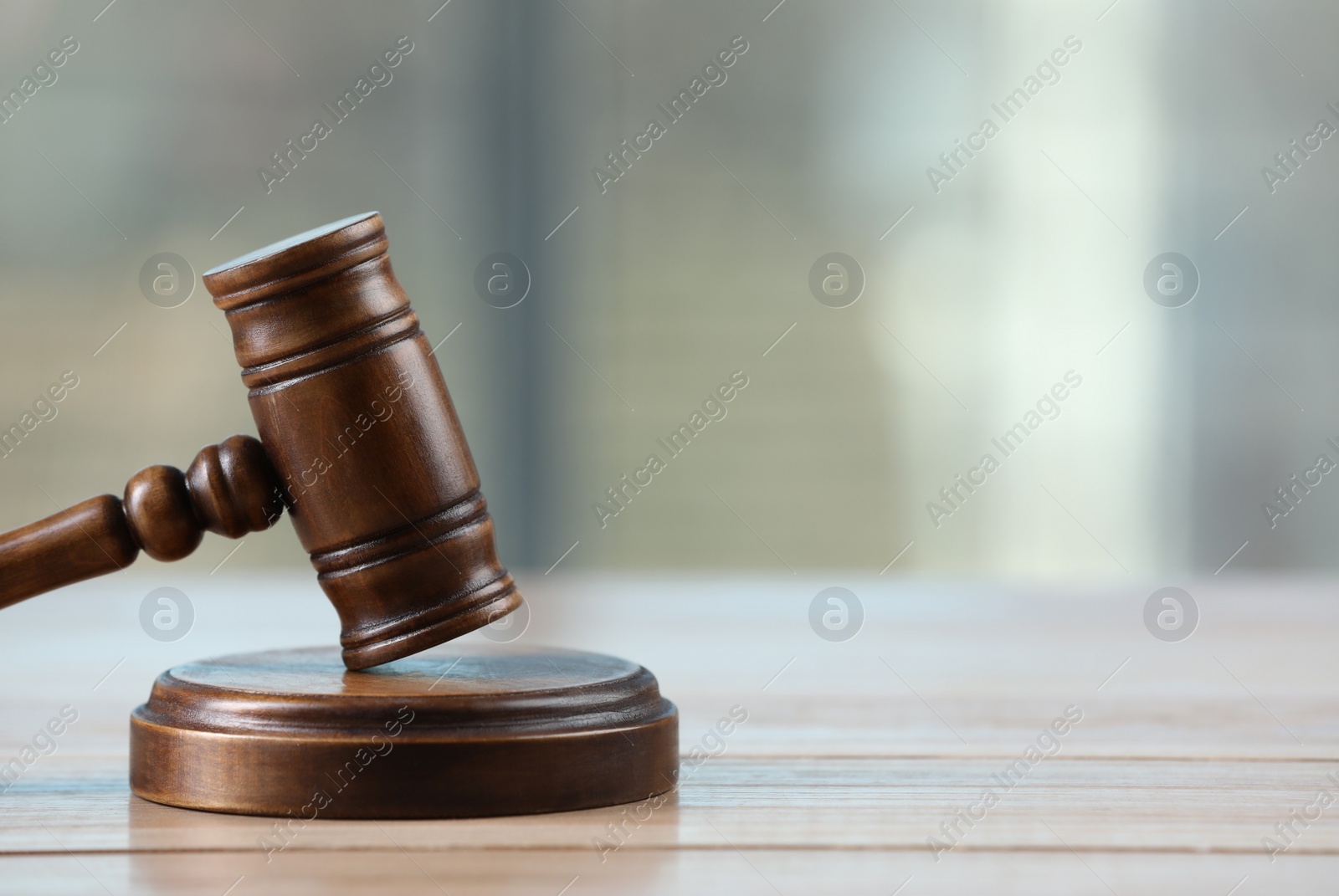 Photo of Wooden gavel on table indoors. Space for text