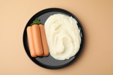 Photo of Delicious boiled sausages, mashed potato and parsley on beige background, top view