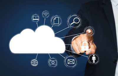 Image of Cloud computing and storage concept. Man pointing at virtual icon on blue background, closeup