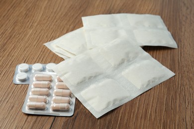 Mustard plasters and pills on wooden table