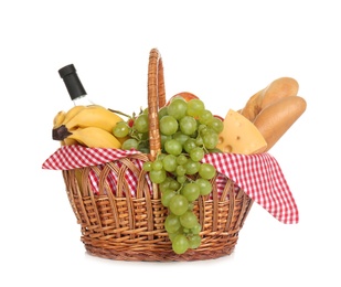 Photo of Wicker basket for picnic filled with food on white background