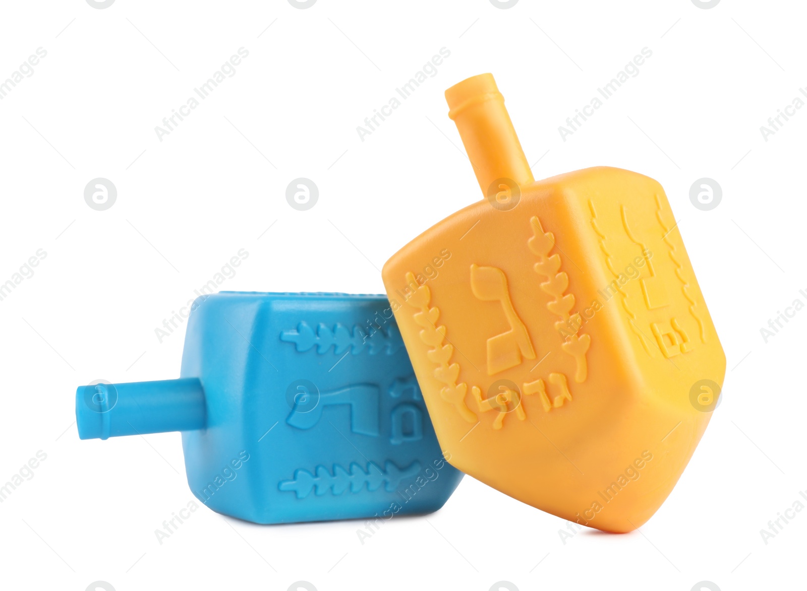 Photo of Hanukkah celebration. Colorful dreidels with jewish letters isolated on white