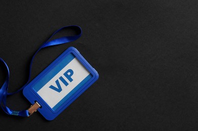 Plastic vip badge on black background, top view. Space for text