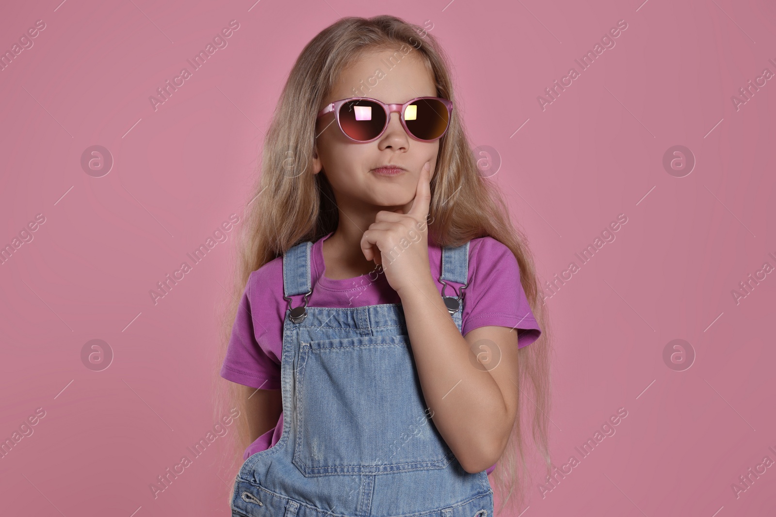 Photo of Girl in stylish sunglasses on pink background