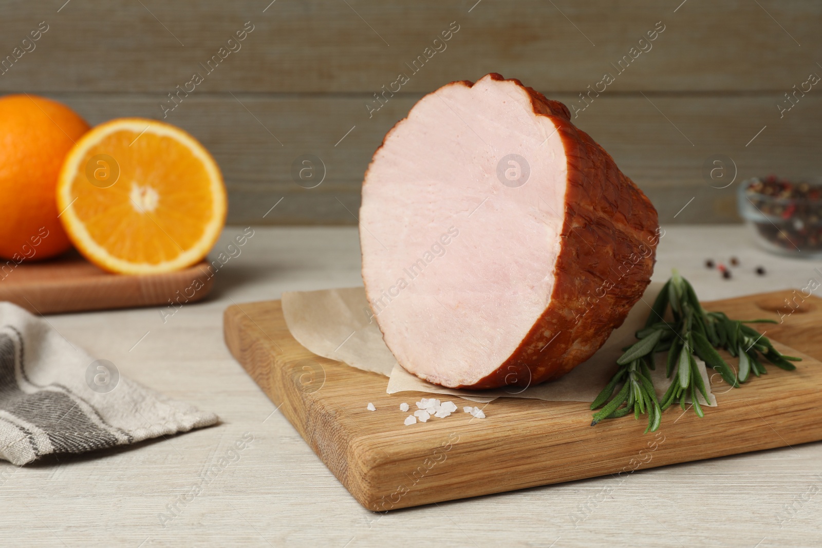 Photo of Delicious ham, rosemary and salt on wooden table