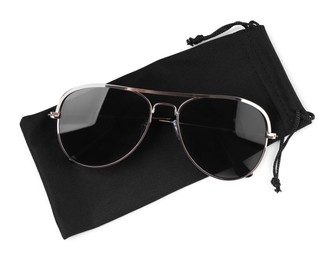 Modern sunglasses with black cloth bag on white background, top view