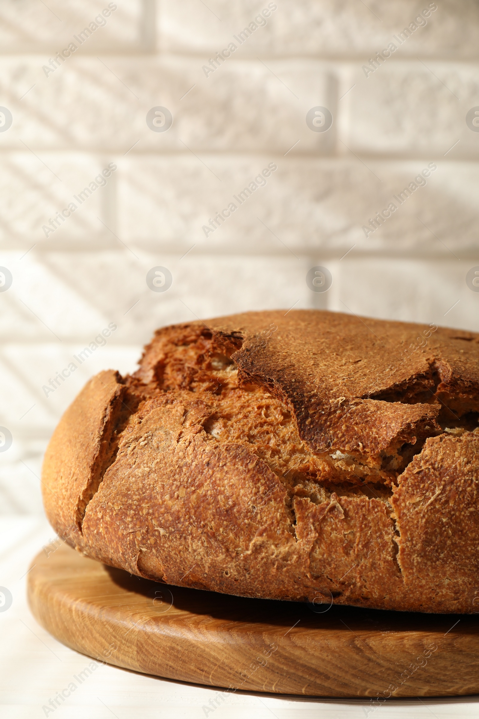 Photo of Freshly baked sourdough bread on white table