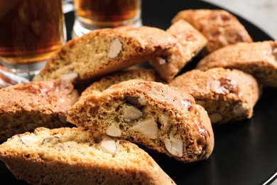 Photo of Slices of tasty cantucci on plate, closeup. Traditional Italian almond biscuits